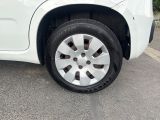 a white car with a flat tire on the street