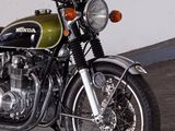 a green and black motorcycle parked in a garage