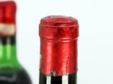 two bottles of wine that are sitting next to each other