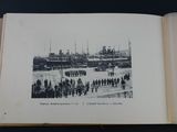 an open book with a black and white photo of a military parade