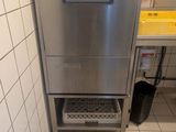 a stainless steel dishwasher in the corner of a kitchen