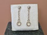 a close up of a pair of earrings sitting on top of a box
