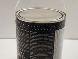 a can of paint sitting on a table with a white background