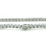 a close up of a diamond bracelet on a white background