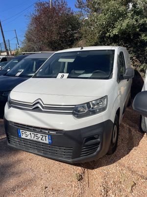 a white van parked in a parking lot next to other cars