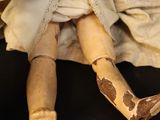 a doll that is sitting on a black surface