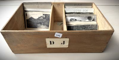 a wooden box that has some old photos inside of it