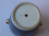 a blue and white vase with a white lid