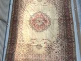 an image of a large oriental rug hanging on a wall