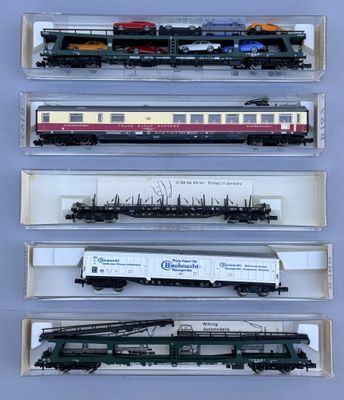 six model trains are lined up in a display case