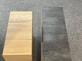 two boxes sitting next to each other on the floor