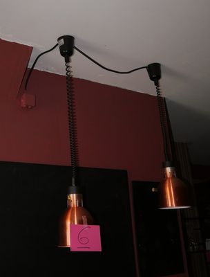 two lights hanging from the ceiling in a room