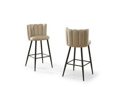 a pair of beige bar stools with black legs