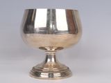 a silver goblet sitting on a silver pedestal