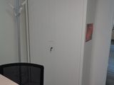 a desk with a chair in the corner of the room