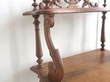a wooden shelf with a clock on top of it