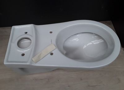 a close up of a white toilet with a wooden seat
