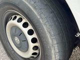 a tire with holes on the rim of a car