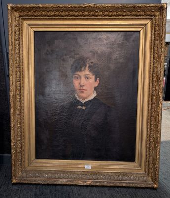 portrait of a young man in a black suit with a gold frame