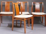 three wooden chairs sitting next to each other on a gray surface