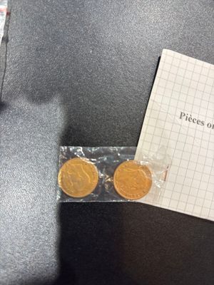 a piece of paper with a piece of gold coins on it