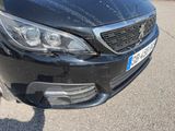 a black car that is parked on the side of the road