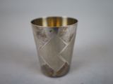 a silver cup that is sitting on a table