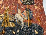 a tapestry with a picture of a man riding a horse
