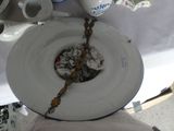 a white plate with a chain hanging from it ' s side