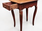an old wooden table with a drawer on top of it