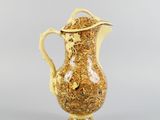 an image of a yellow and white vase with a gold lid