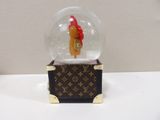 a small snow globe with a red hat on it