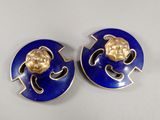 pair of blue and gold earrings with a gold lion head