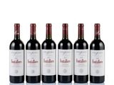 four bottles of red wine are lined up on a white surface