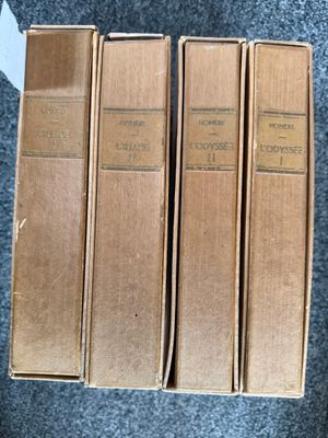three books are stacked on top of each other on a blue carpet