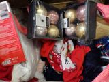 a box full of christmas ornaments in a pile