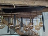 many light bulbs hanging from the ceiling in this room