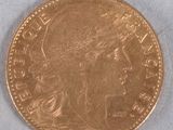 a close up of a gold coin with a woman ' s head on it