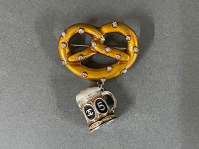 a pretzel shaped brooch with a skull on it