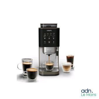 un gros plan d'une machine à café avec deux tasses de café devant