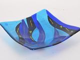 blue and black glass bowl with wavy design on it