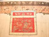 a red oriental rug on the floor in a room