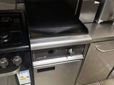a kitchen with a stove, oven, sink, and dishwasher