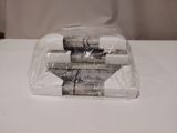 a stack of books wrapped in plastic sitting on a table