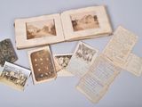 an open book with old photos and old letters on a table