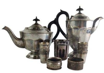 a silver tea set with cups and a teapot