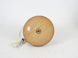 a close up of a wooden spool with a cord attached to it