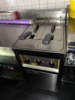 an image of a commercial kitchen with a stove and oven