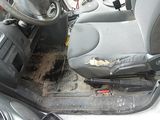 a picture of a dirty car with a broken steering wheel