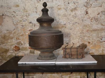 a large metal object sitting on a table in front of a brick wall